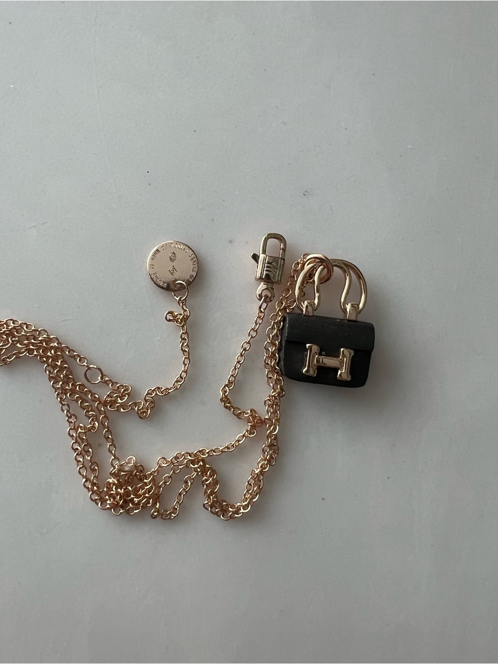 Hermes gold-tone chain necklace with black bag charm